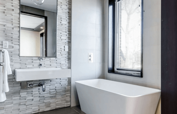 trending white bathtub with window and wooden flooring