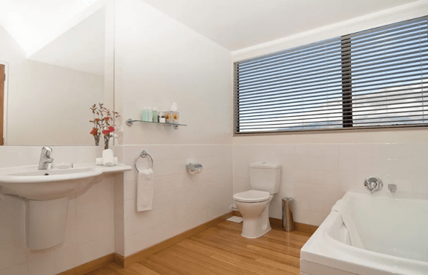 white thyme luxurious bathroom with wooden floor