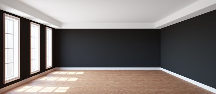 Black walls and wooden flooring