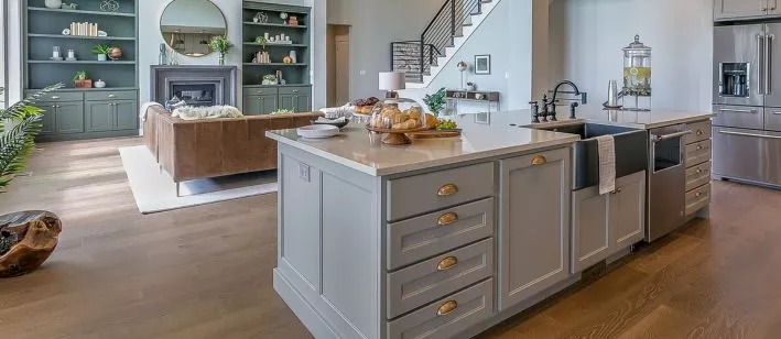 A kitchen design with a sink and a couch in it