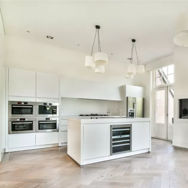 white kitchen with a sizable island in the center